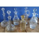 Etched amber and clear glass decanter and six other assorted glass decanters