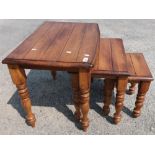 Nest of three hardwood occasional tables on turned supports