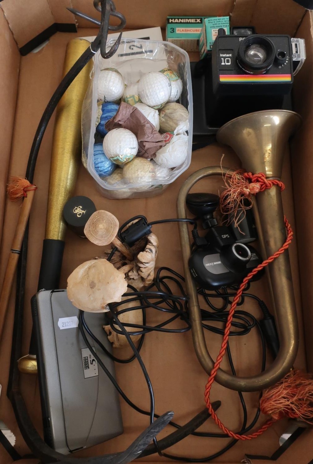 Scales hanging pan, various golf balls, carved wood items, vintage Polaroid camera, John Player