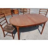 Macintosh teak extending dining table and set of four chairs (for reupholstery)