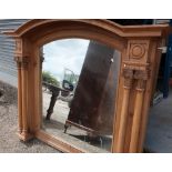 Extremely large Victorian style pine framed over mantel mirror with arched top and carved column