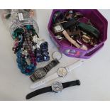 Box of various assorted wristwatches and a tub of costume jewellery