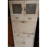 Circa 1960s painted retro style kitchen cabinet with two upper glazed doors above two drawers,