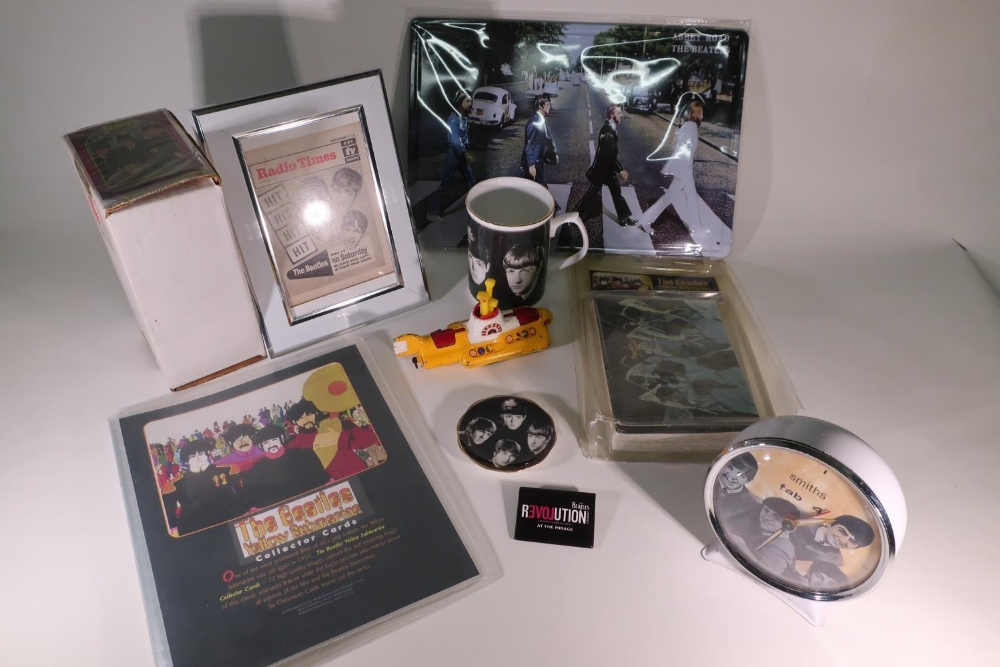 Collection of various The Beatles memorabilia including bubble gum cards, mug, alarm clock, Corgi