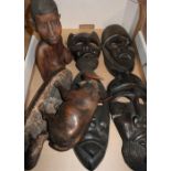 Pair of double headed carved wood African carved tribal masks, another carved wood figure of a water