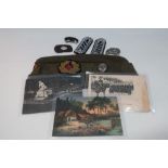 German military side cap, three German postcards, various badges, shoulderboards, etc