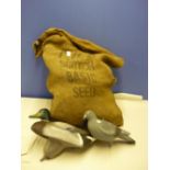 Hessian bag containing a quantity of various assorted pigeon decoys