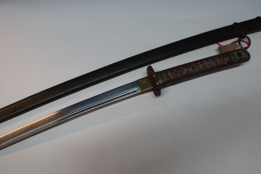 Mid 20th C Japanese sword with 26 1/2 inch blade, pierced bronze tsuba, cast metal grip complete