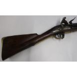 Flintlock Brown Bess type musket with 46 inch barrel with brass mounts and ramrod, the stock stamped