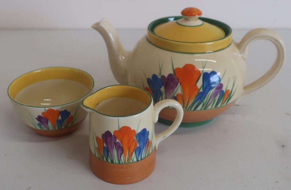 Clarice Cliff Bizzare Crocus pattern trio comprising: teapot, milk jug and sugar basin