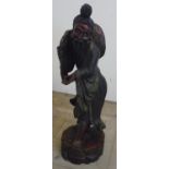 A large carved wood Chinese figure of an elderly gentleman on circular base, with traces of