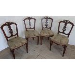 Set of four Victorian walnut framed dining chairs with pierced scroll cresting and lyre splats, on