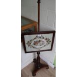 Early 19th C rosewood pole screen, rectangular woolwork banner on vase turned column supports and