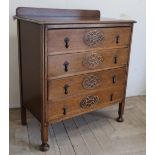 1930s medium oak chest of four drawers, oval blind fretwork decoration, on bun feet (84cm x 45cm x