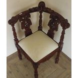 Chippendale style elaborately carved mahogany corner chair with drop-in upholstered seat, on