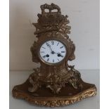 19th C French gilt metal mantel clock with white enamel dial and striking movement, on raised gilt