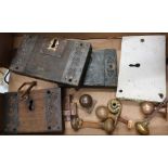 Selection of various early heavy metal and oak bound door locks, brass door knobs etc