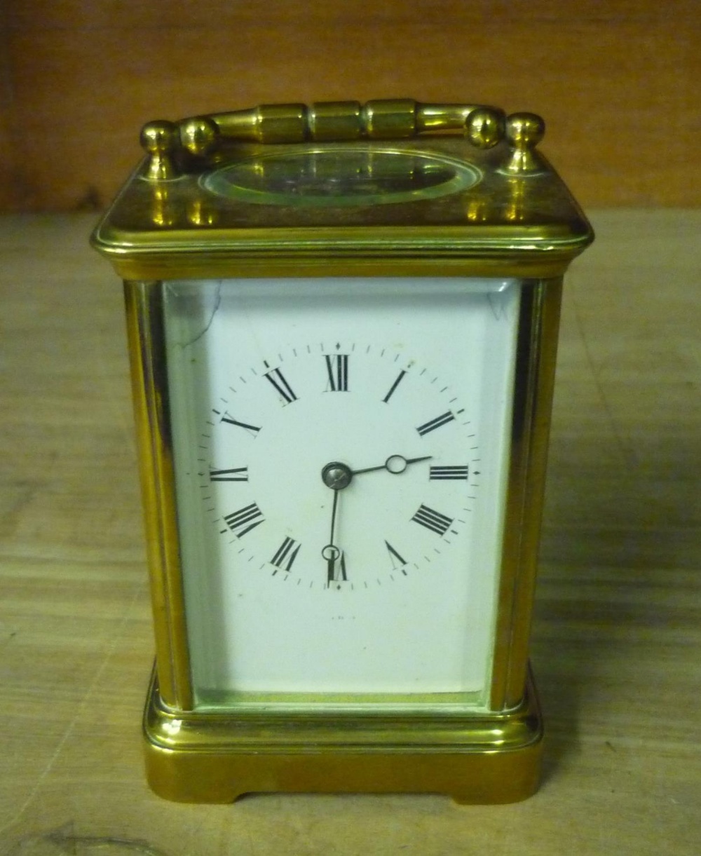 Early 20th Century brass carriage clock, bevelled glass panels with white roman dial, twin train