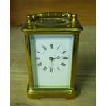 Early 20th Century brass carriage clock, bevelled glass panels with white roman dial, twin train