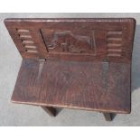 Unusual Spanish folding bench seat with hinged top and carved central figure of a bull, on four