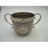 Late Victorian silver loving cup with swan necked twin handles, repouse and gadrooned decoration