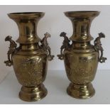 Pair of Japanese brass vases with twin fish designed handles, bodies with foliage design (33cm)