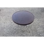Vintage coffee table, circular Bakelite top, on three metal supports (60cm x 51cm)