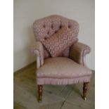 Victorian style upholstered armchair, with deep buttoned fan back, on turned supports