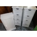 Pair of white finished four drawer narrow chests and a similar wall cupboard (3)