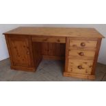 Large modern pine twin pedestal desk with central drawer flanked by three drawers and single