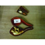 Cased Meerschaum type pipe with amber tip in the form of a boy boating, and a cased cheroot holder