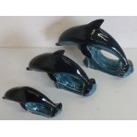 Graduated set of three Poole Pottery dolphins