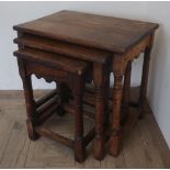 Nest of three oak occasional tables on turned supports