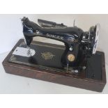 Singer sewing machine on rectangular oak base, serial number Y886519