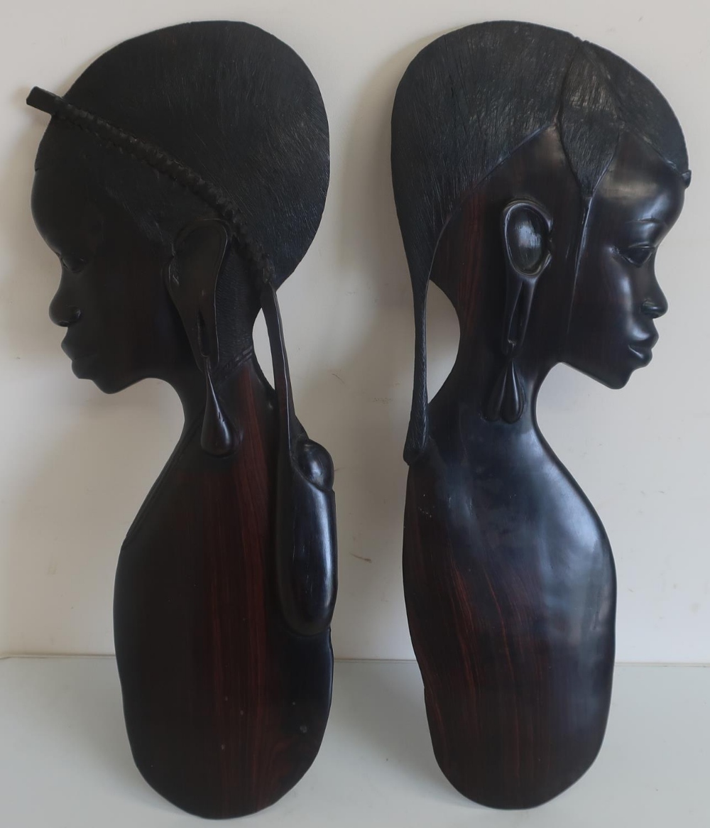 Pair of Eastern carved hardwood wall plaques in the form of females (height 59cm) (2)