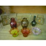 Cranberry glass single handled vase, a small cranberry vase, similar vase with a vaseline tint