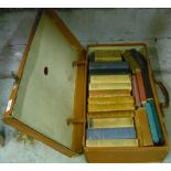 Vintage tan leather suitcase containing various books including half leather bound 'On Horseback