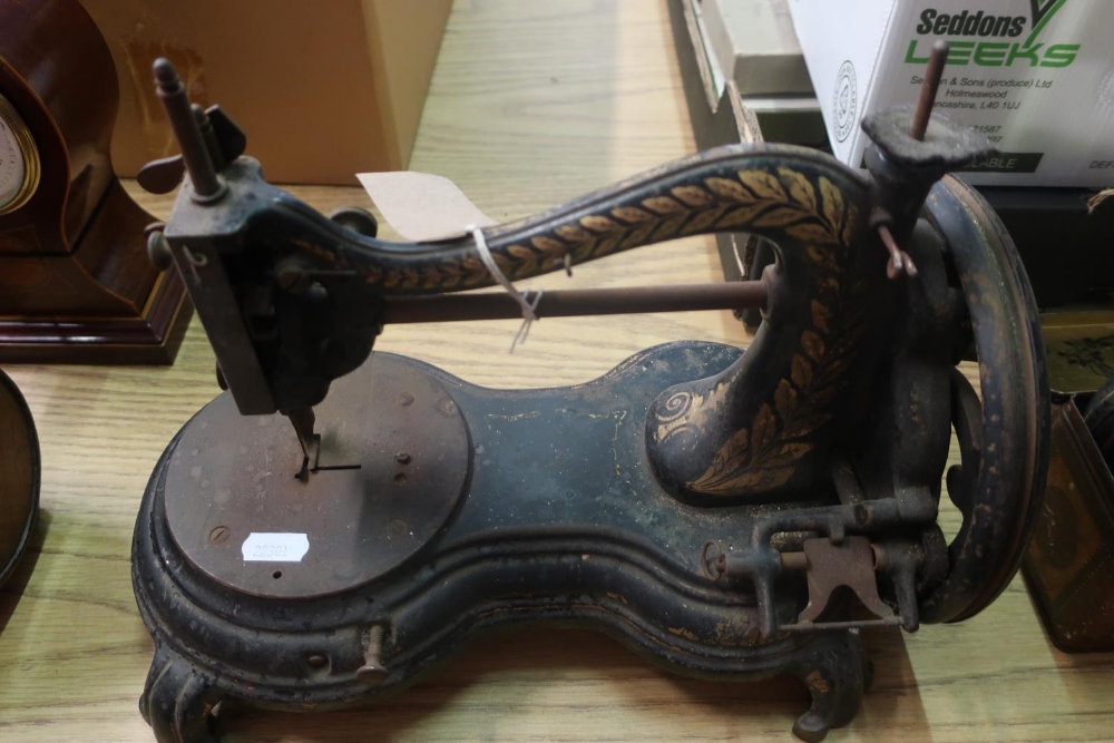 Vintage sewing machine, possibly Smith & Sons, shaped base with scroll feet and gilt detail (