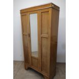 Edwardian light oak wardrobe with panelled front and single mirrored door (184cm x 94cm x 40cm)