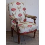 Late Victorian walnut open arm chair with upholstered seat back and arms, on turned fluted legs