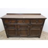 Reproduction oak dresser, with three drawers above three doors with carved detail