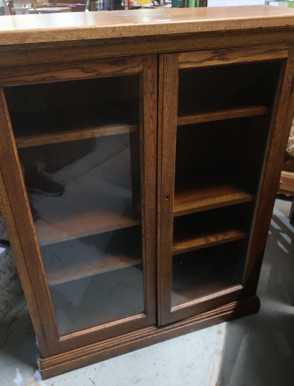 20th Century Oak bookcase, adjustable shelves, enclosed with glazed doors, plinth base (7cm x