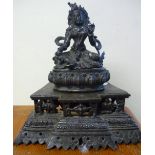 Cast bronze Eastern figure of a deity, with inset turquoise type stones on stepped base (height