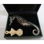 Flora Metallica Australian hollow copper and sterling silver sea horse, and a carved bone pendant