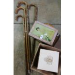 Collection of four walking sticks with various crest badges, sealed bottle of Bells Scotch Whisky,