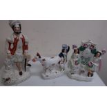 Group of three Staffordshire figures, including flat back courting couple clock, Highland