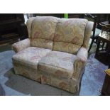 G Plan two seater semi wingback settee in floral pattern material