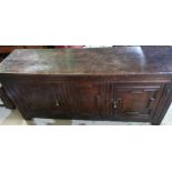 George III oak backless dresser, twin planked top above a pair of geometrically molded doors, with