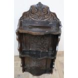 Antique oak shelf, three shaped tiers with carved back and cresting, bears date 1713 (54cm x 39cm)