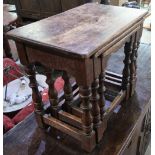 Nest of three oak rectangular occasional tables on turned supports, joined by stretchers (55cm x